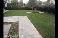 Tuinaanleg met bestrating van siertegels en gazon van graszoden