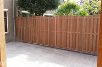 Achtertuin met bestrating in wildverband en houten schutting