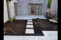 Tuinaanleg met bestrating van keramische tegels en nieuwe planten