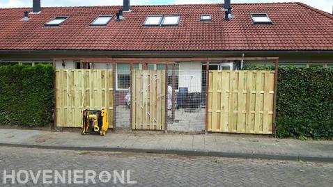 Schutting van hout en betongaas met tuinpoort