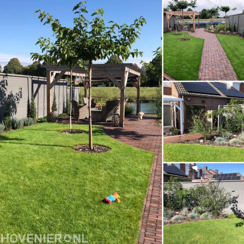 Aangelegde achtertuin met gazon, beplanting en terras