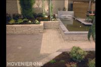 Strakke vijver met waterloop en borders van stapelblokken