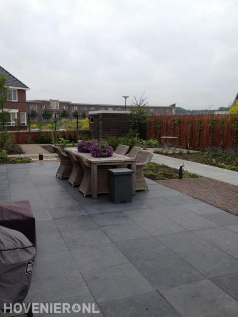 Strakke tuin met terras, borders en hedera schutting 1