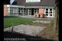 Achtertuin met groot terras, gazon en buitenverlichting