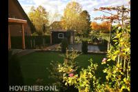 Tuin met hoogteverschil en overkapping en schuurtje van Douglas hout