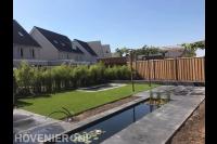 Tuinaanleg met vijver, gazon, trampoline en bestrating