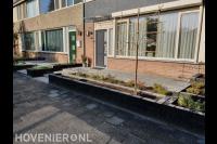 Voortuin met plantenbakken van stapelstenen