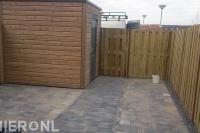 Houten schutting met poort en sierbestrating