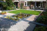 Achtertuin met terras, bestrating, gazon en kleine vijver