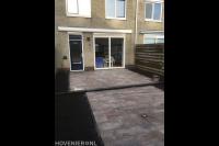 Aanleggen achtertuin met natuursteen tegels en borders