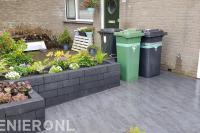 Voortuin met plantenbak en natuursteen tegels