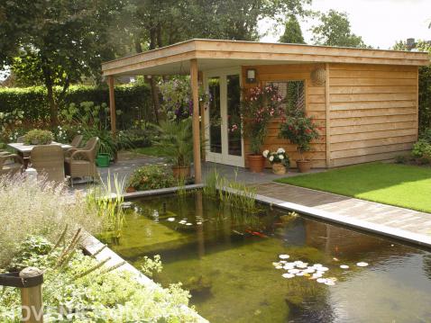 Houten tuinhuis met overkapping bij vijver