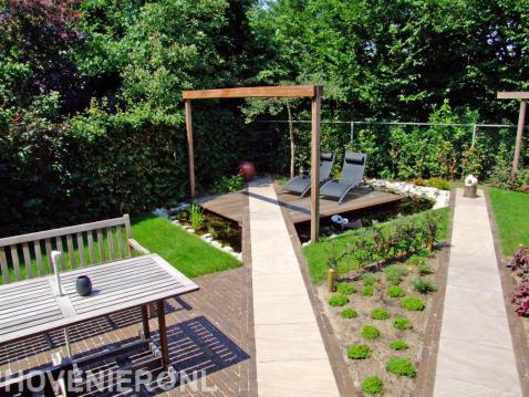 Zithoek met vlonder en houten pergola boven vijver 1