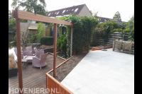 Tuin aan het water met vlonder, pergola en hoger gelegen terras