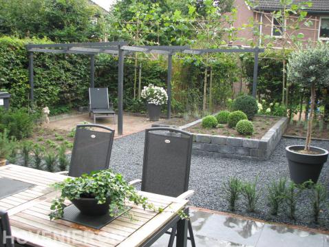 Achtertuin met terras, pergola en leibomen