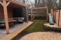 Familietuin met houten overkapping en gebakken klinkers