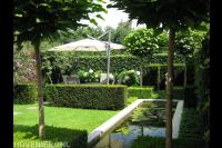 Sfeervolle tuin met vijver, hagen, hortensia's en catalpa's