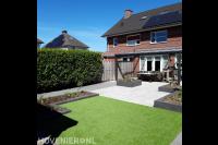 Aanleg achtertuin met sierbestrating, terrasoverkapping en kunstgras