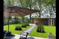Ontwerp en aanleg nieuwe tuin met terrassen, blokhagen en overkapping