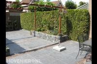 Terras van natuurstenen tegels met houten pergola 2