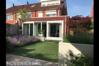 Moderne tuin met overkapping en witte bloempotten en plantenbakken 2