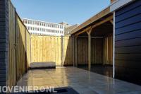 Achtertuin met schutting, bestrating en overkapping