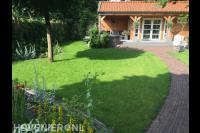 Achtertuin met sierbestrating en gazon